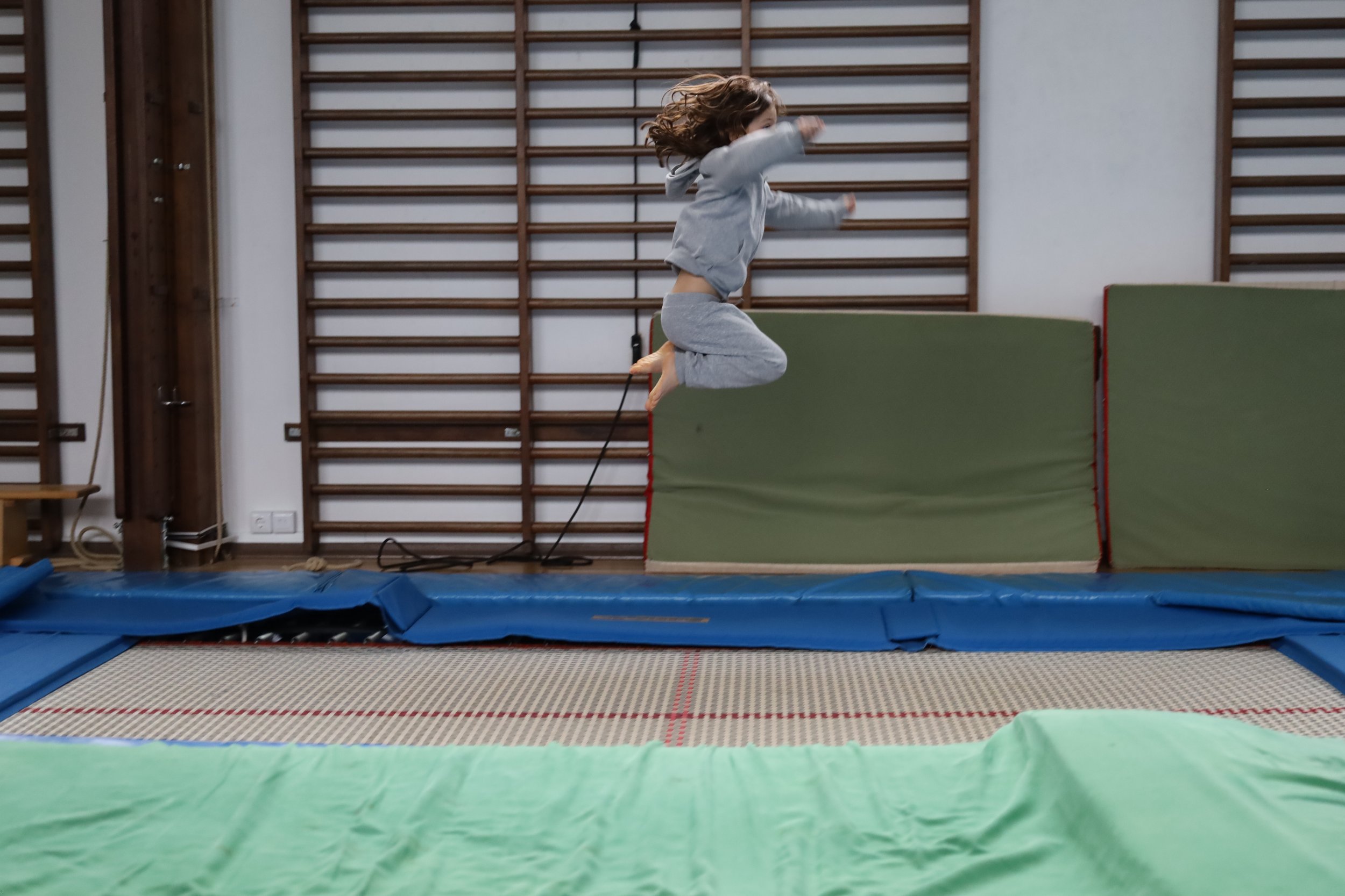 Preschool child jumping on a trampoline