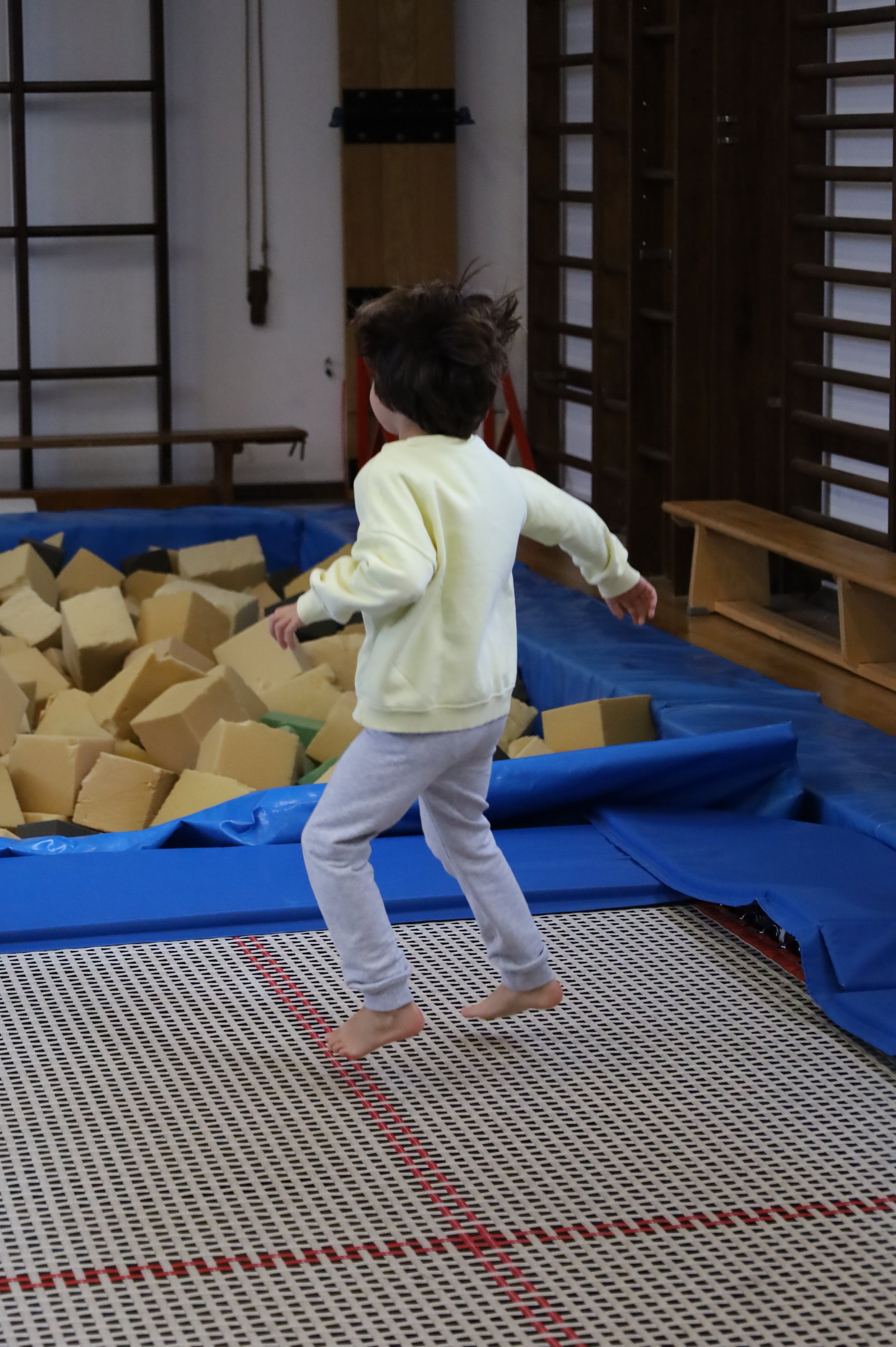 Preschool child jumping on a trampoline