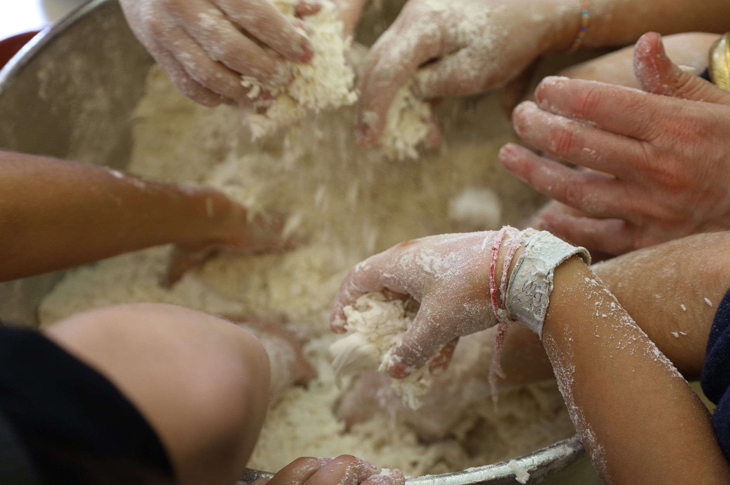 Preschool children mixing dough during a cooking activity