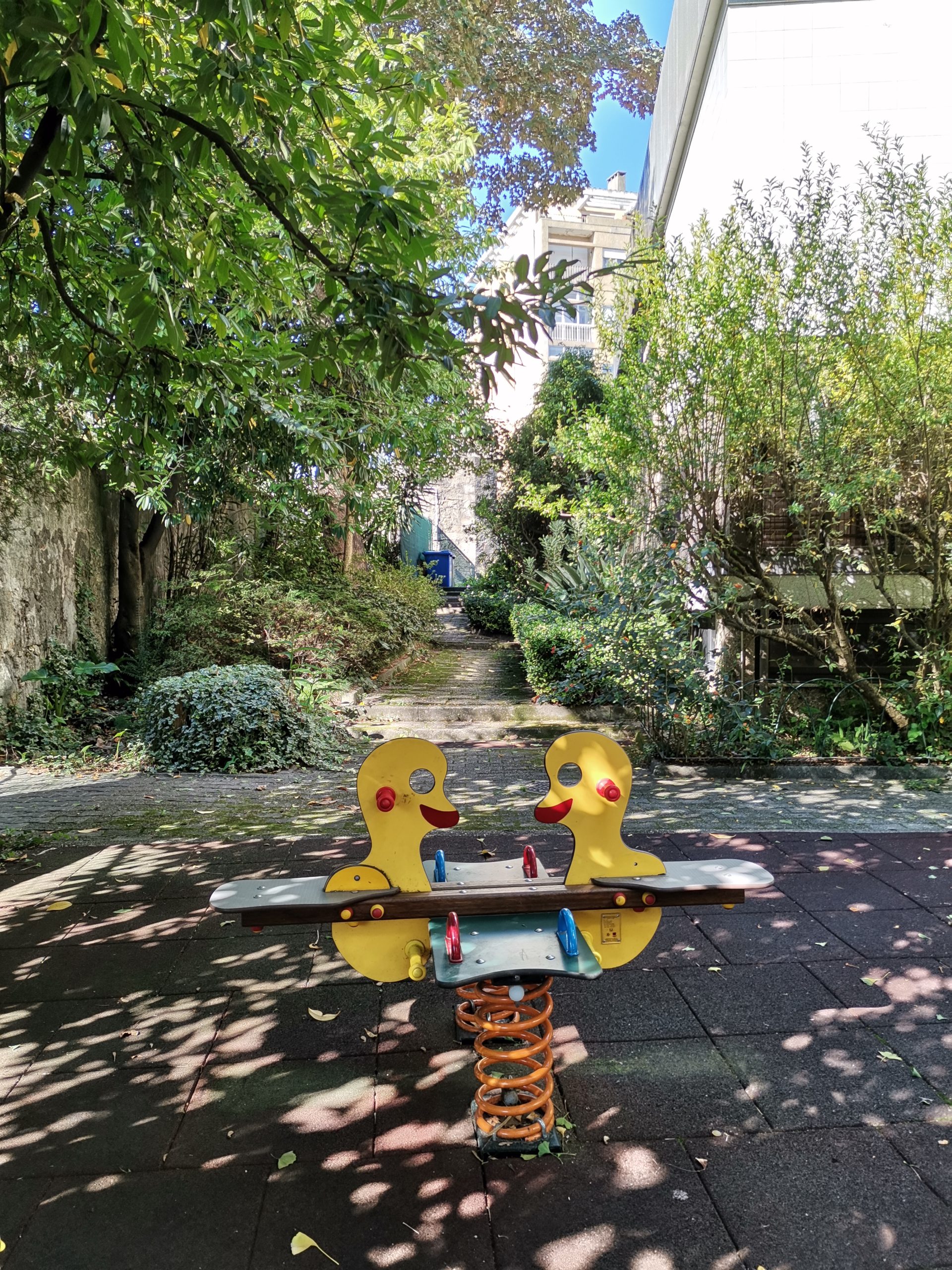 seesaw playground equipment in a school garden