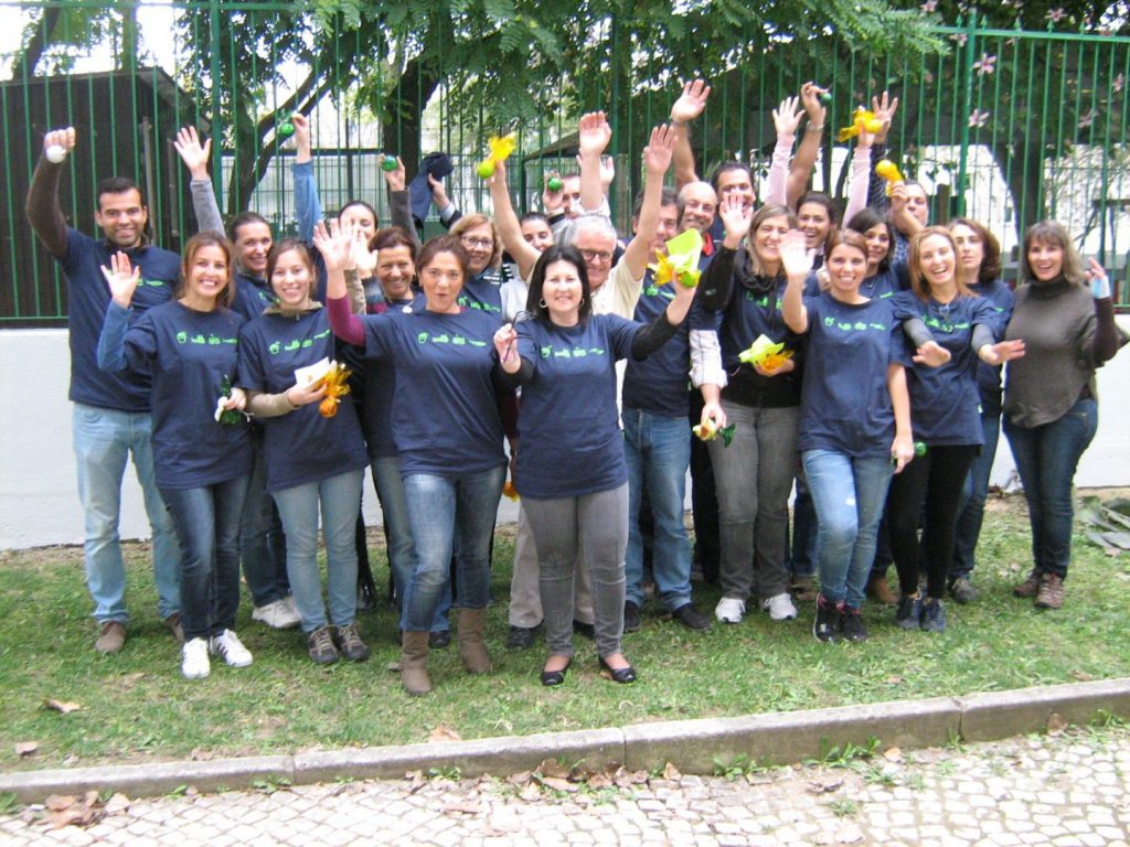 Group photo of Creche Caritas staff and children participating in an outdoor activity