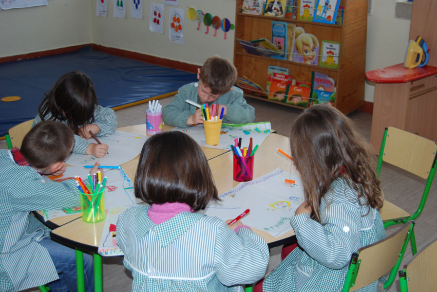 Preschool children drawing and painting in a classroom