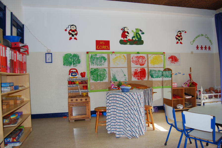Preschool classroom with colorful artwork and play area