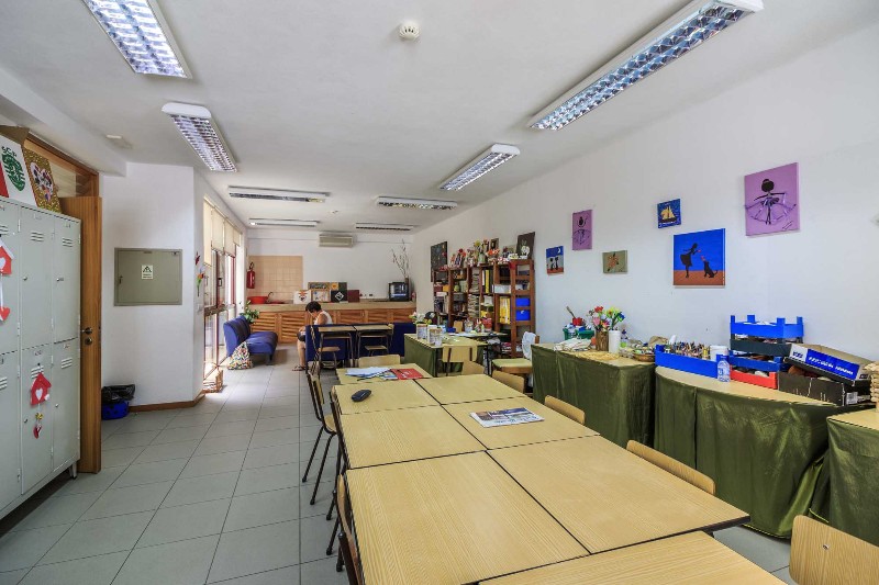 Preschool classroom with tables, chairs, and art supplies