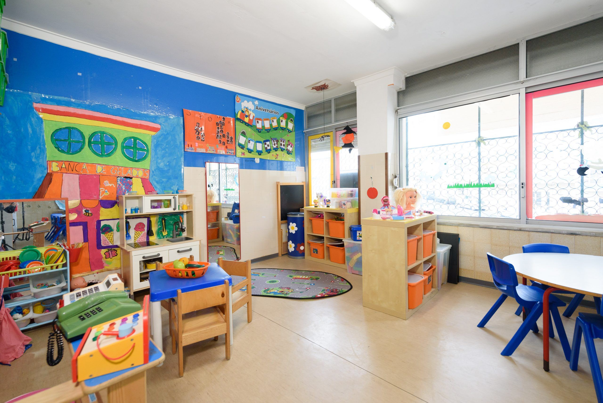 Preschool classroom with colorful walls, toys, and play area