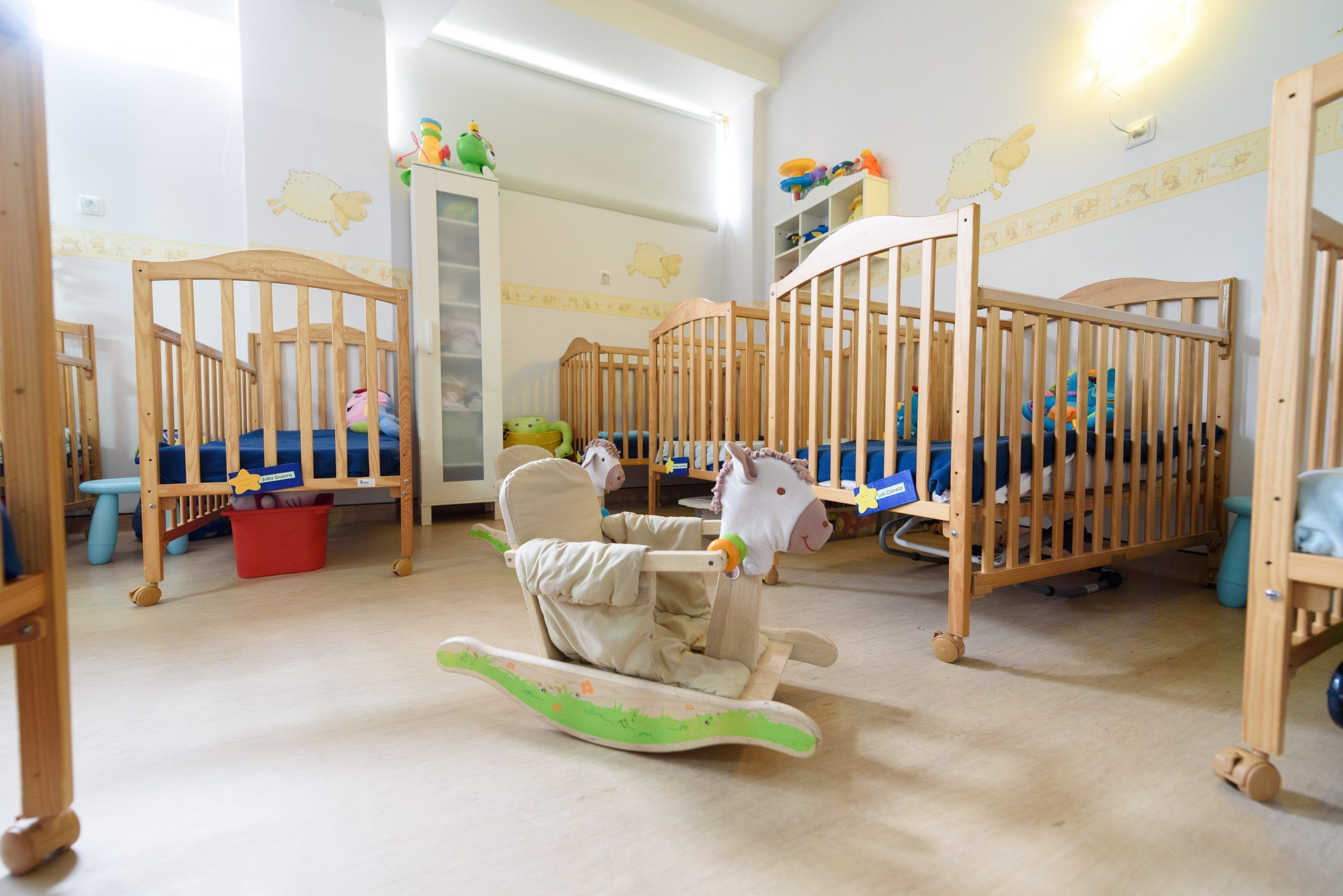 Preschool classroom with cribs and toys