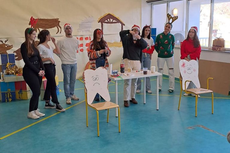 Preschool teachers and students participate in a Christmas themed educational activity.