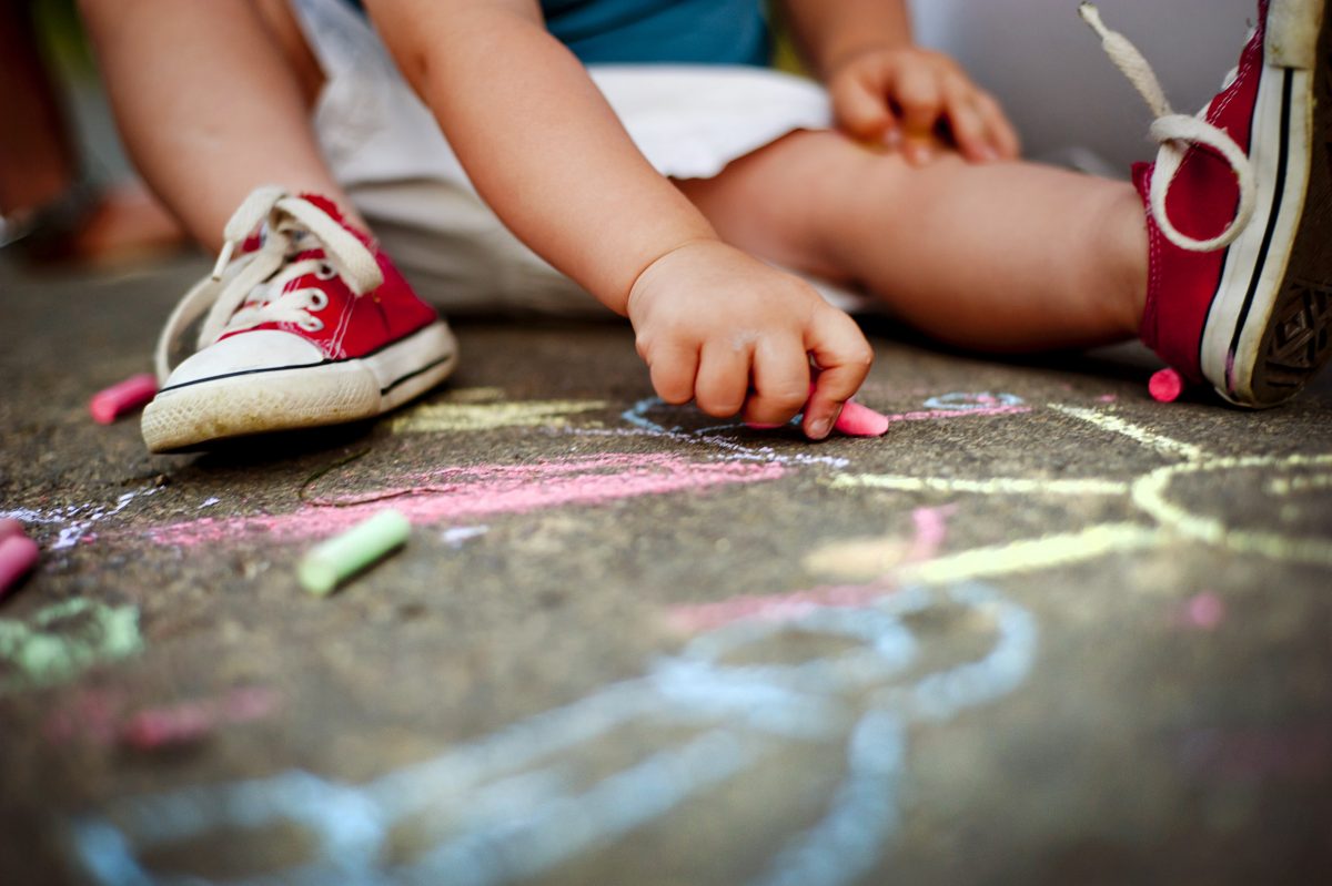 Child drawing with chalk