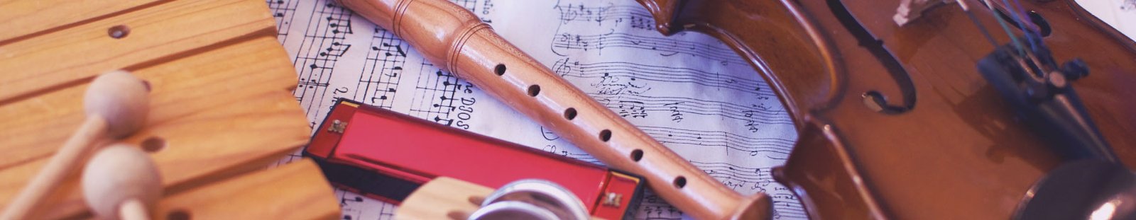 Musical instruments including a violin, flute, and xylophone on sheet music