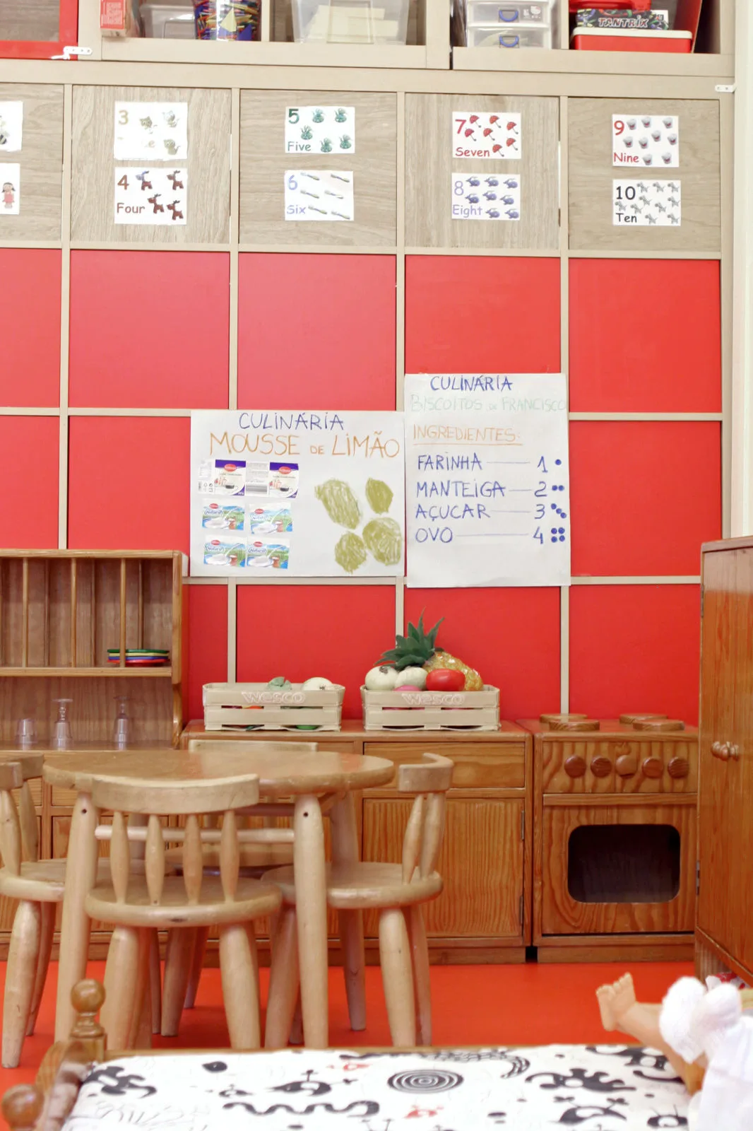 Preschool classroom with a play kitchen and number charts