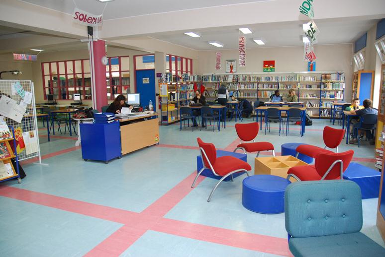 Preschool library with colorful furniture and students reading books