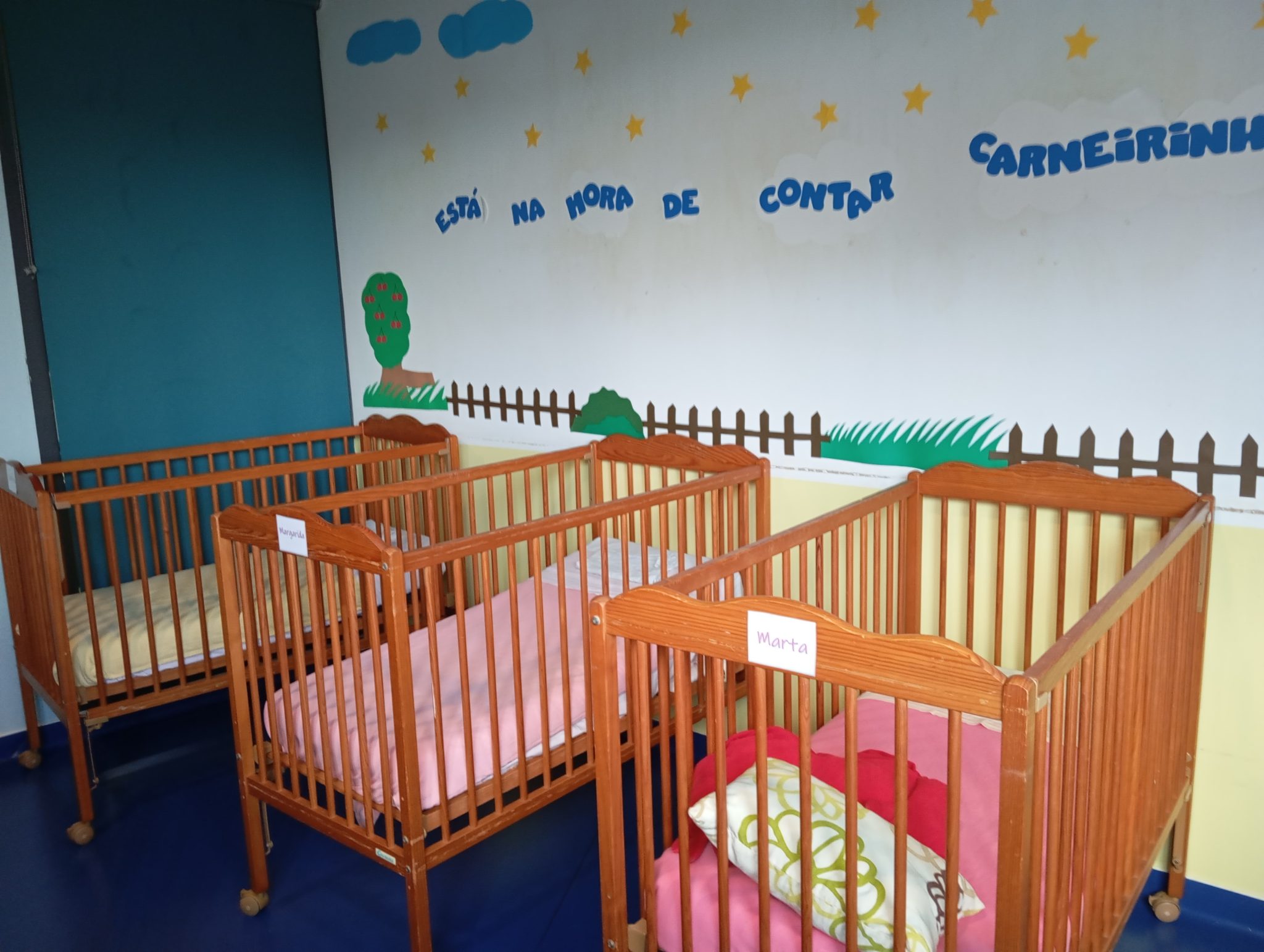 Preschool nap room with several cribs