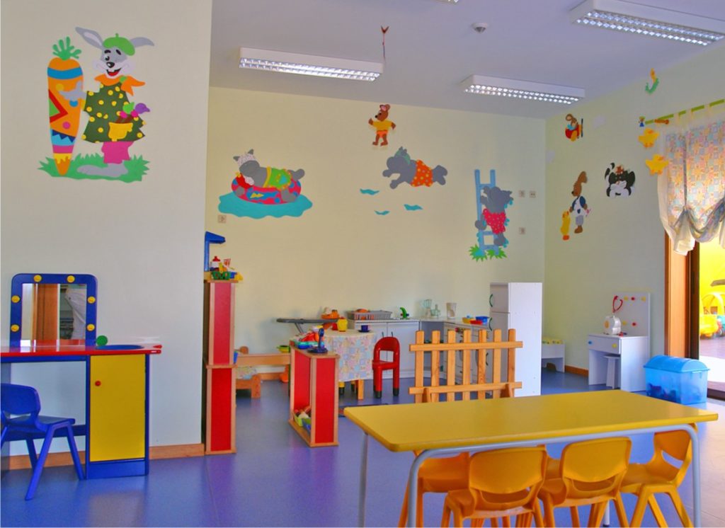 Preschool classroom with colorful furniture and playful wall decorations