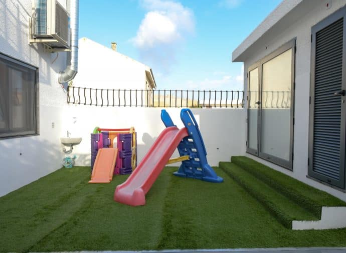 Preschool playground with slide and climbing frame