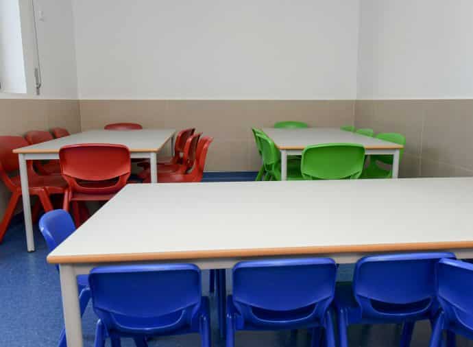Preschool classroom with colorful tables and chairs