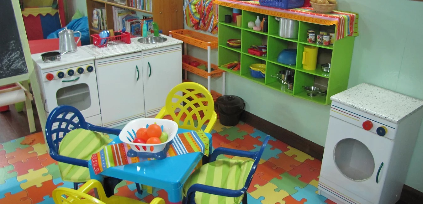Preschool play kitchen with colorful toy appliances and furniture