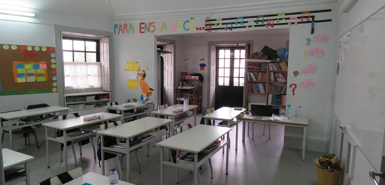 Preschool classroom with tables, chairs, and educational materials
