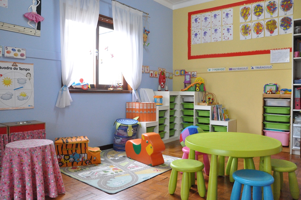 Preschool classroom with colorful furniture, toys, and educational materials