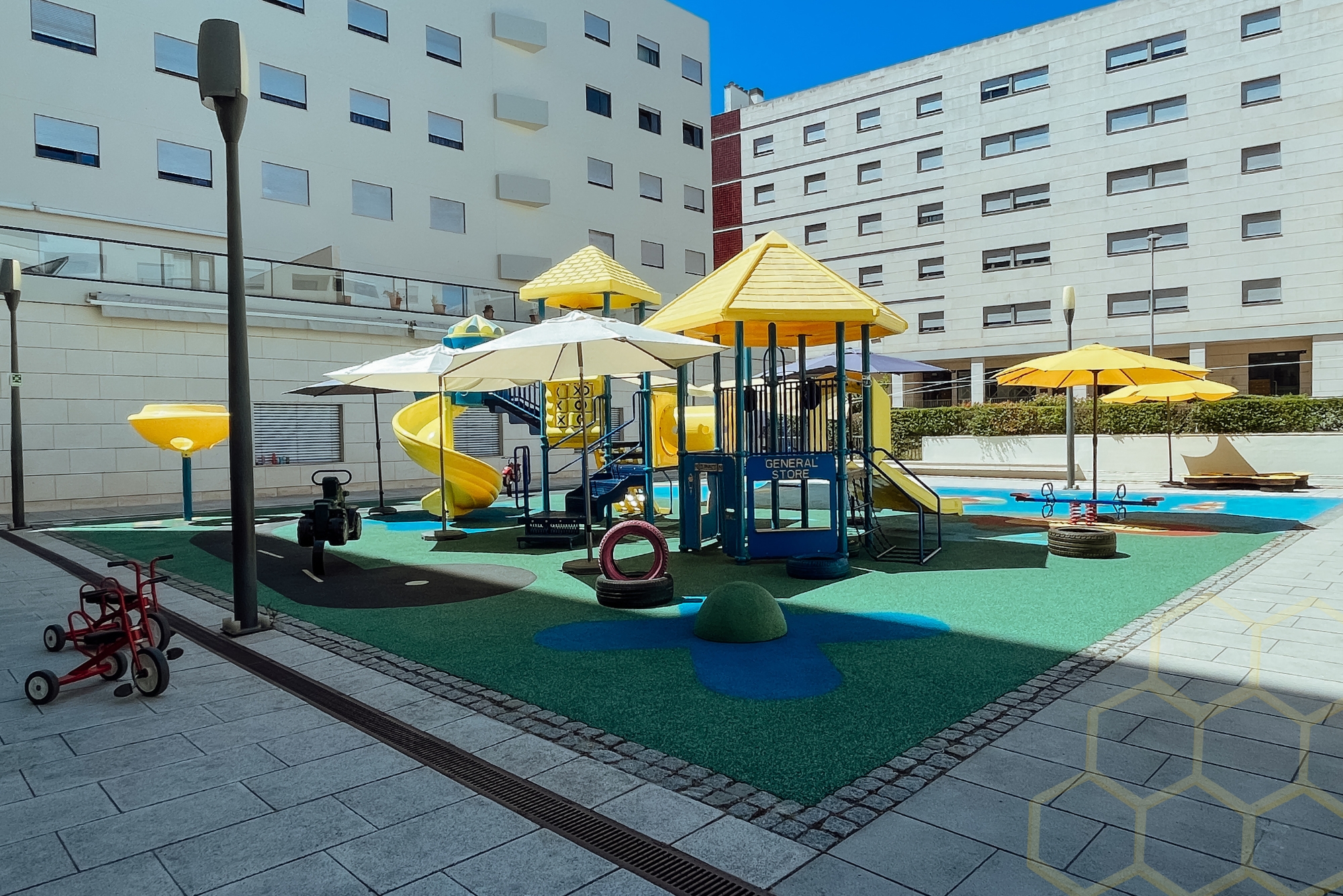 Beehive House preschool playground with colorful play structures and equipment