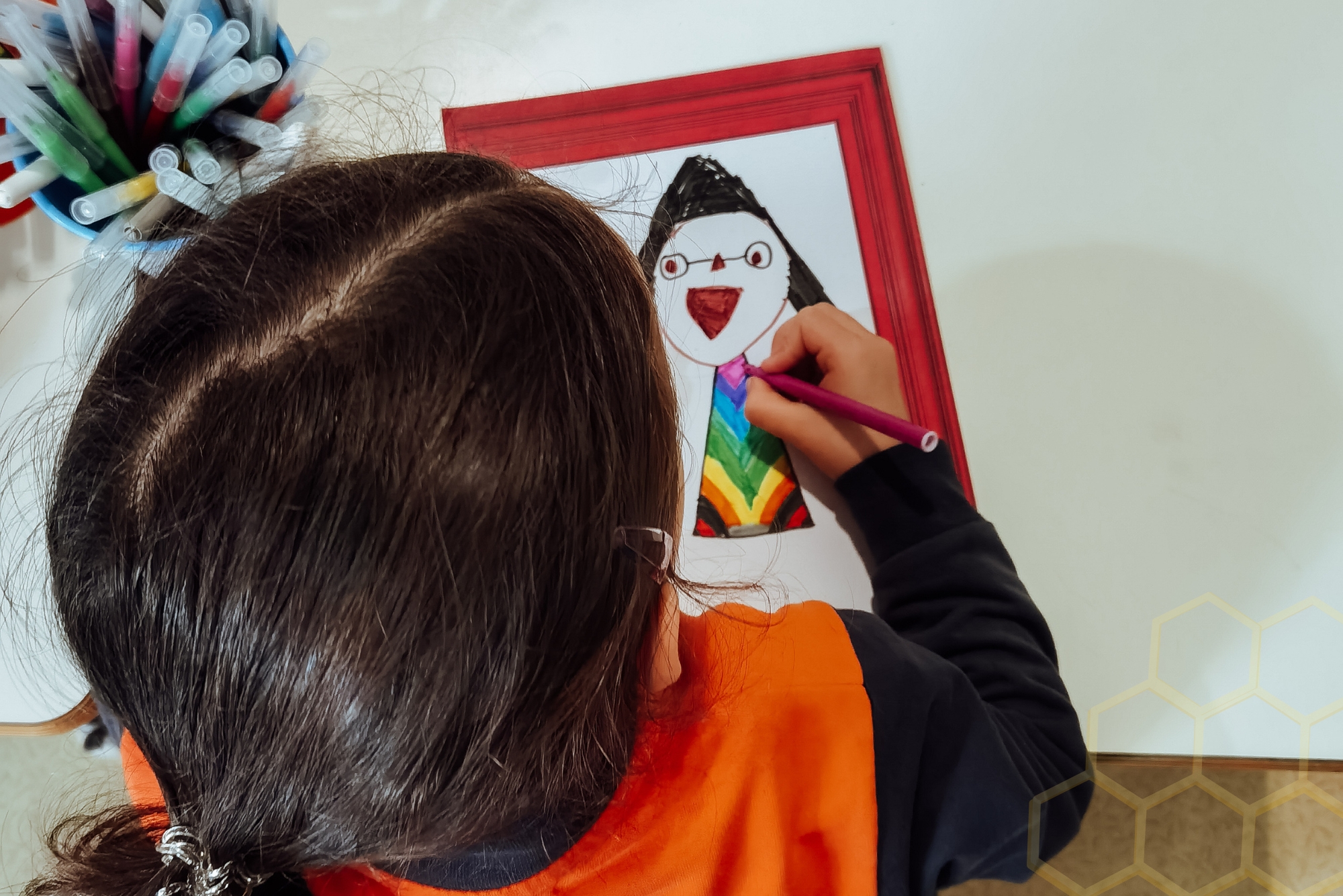 Preschool student drawing a colorful picture