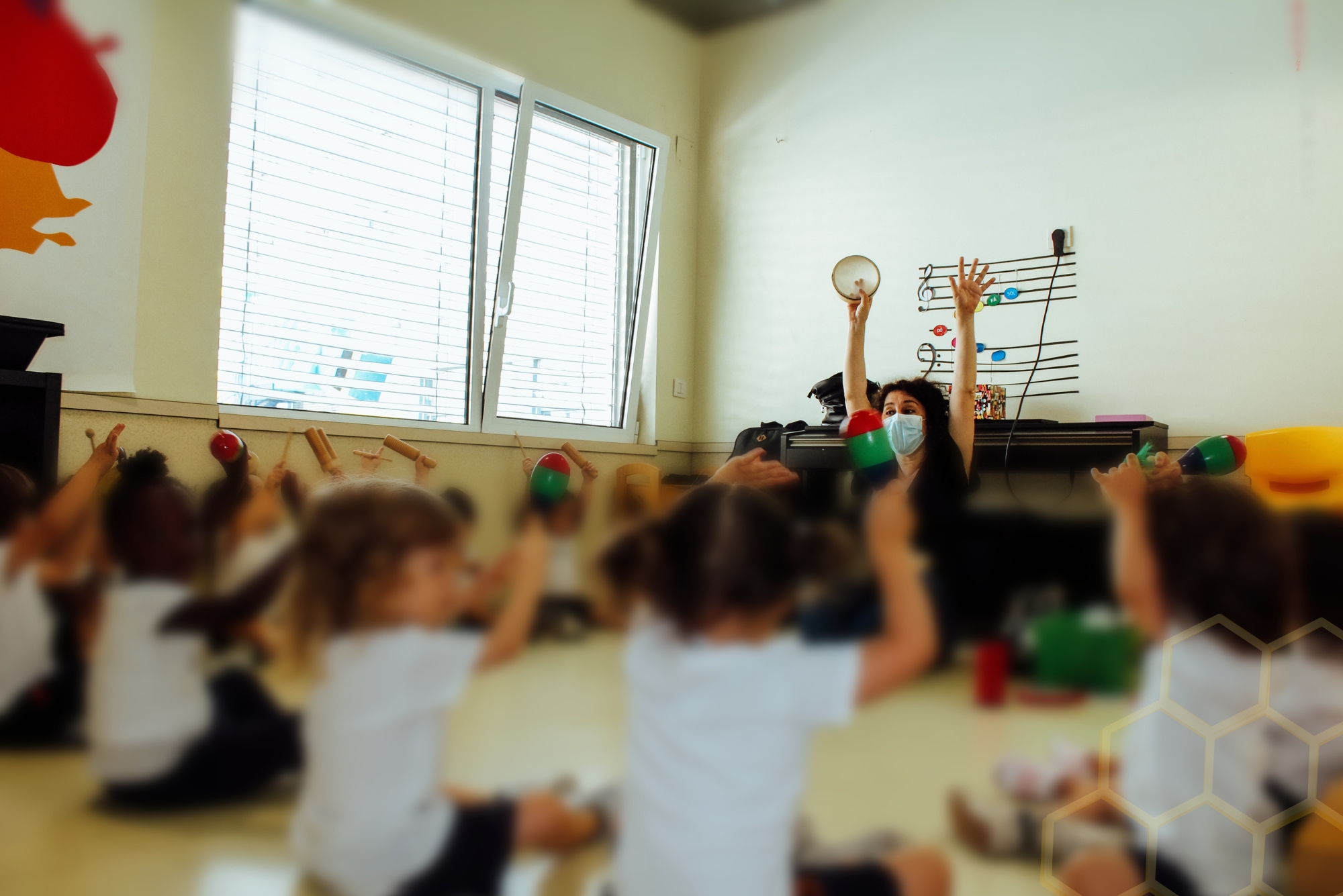 Preschool music class: children playing musical instruments with their teacher