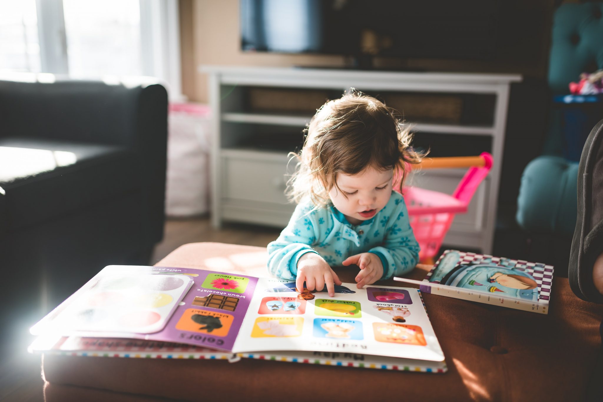 Toddler looking at a book