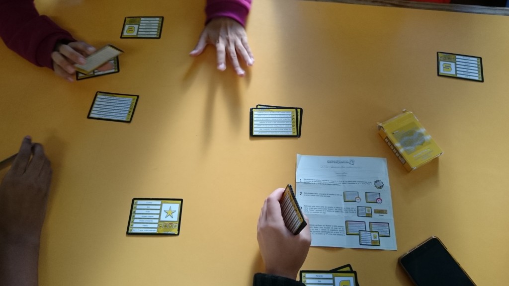 Preschool children playing a card game at a table