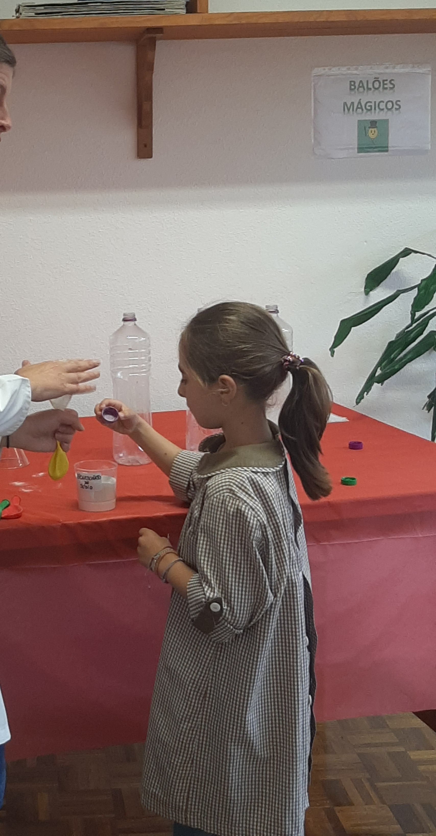 Preschool student participating in a science experiment involving balloons