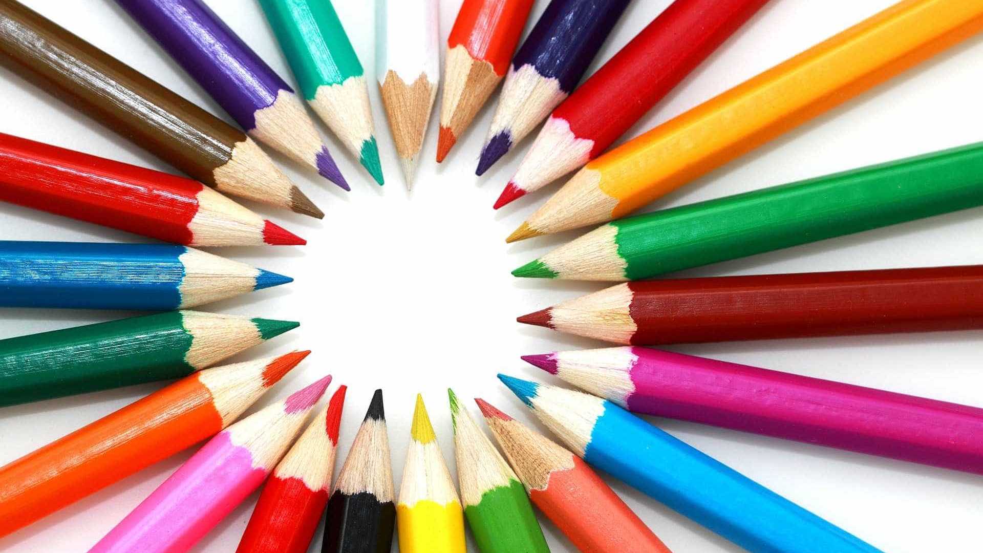 Colored pencils arranged in a circle on a white background