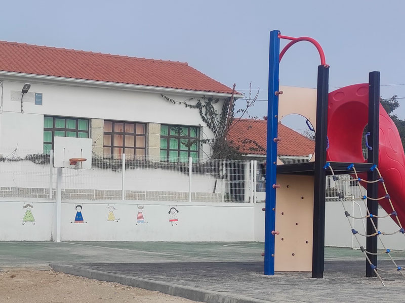 Preschool playground with slide and climbing structure