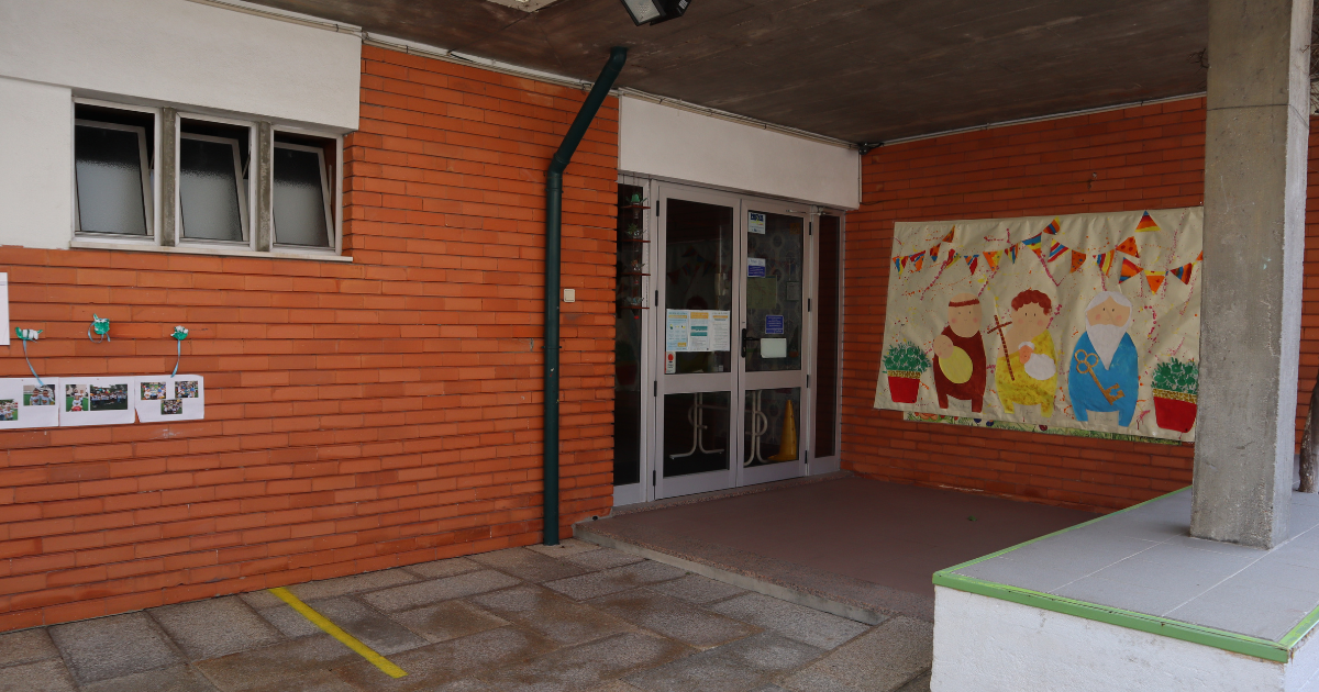 Exterior view of CIVAS preschool, showing the entrance with a colorful mural and children's artwork displayed.