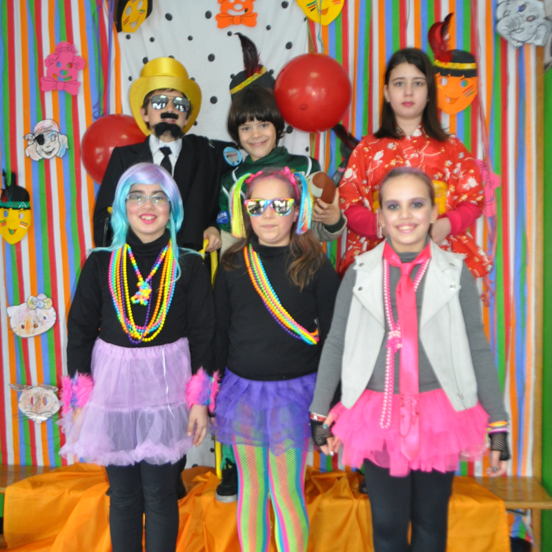 Preschool students dressed in colorful costumes for a school event.
