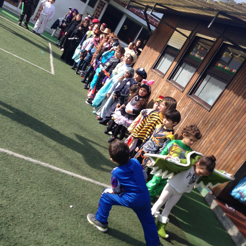 Preschool children in costumes lined up outdoors