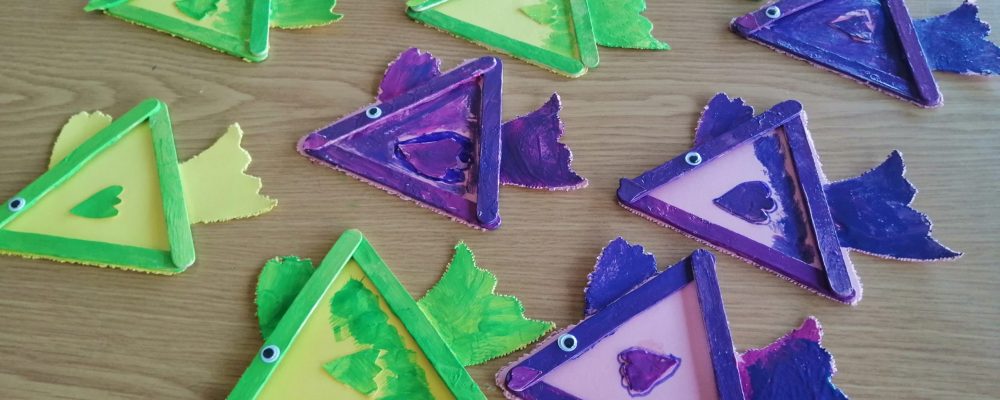 Preschoolers' colorful fish crafts made from popsicle sticks