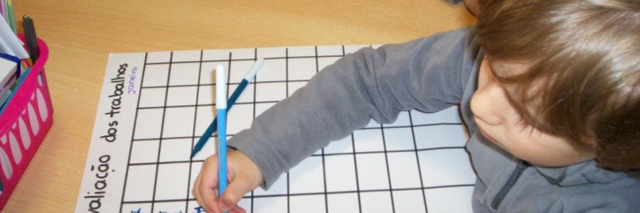 Preschool student working on a grid worksheet