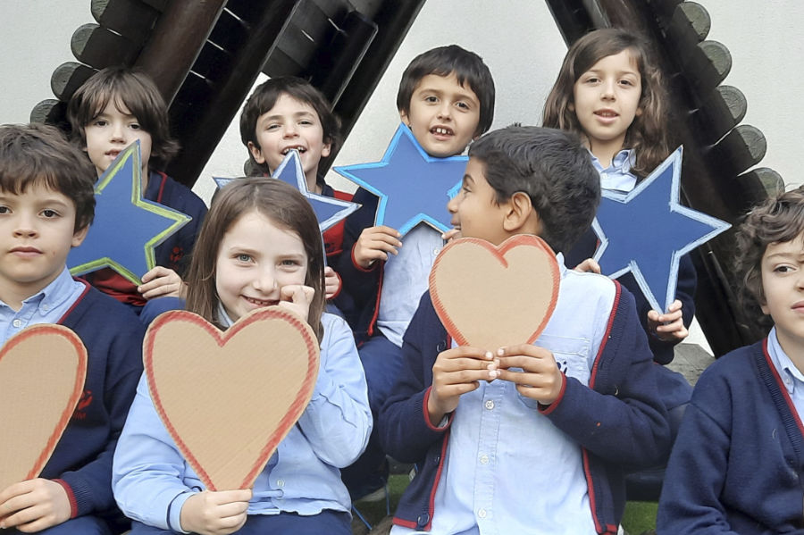Preschool children holding heart and star shapes