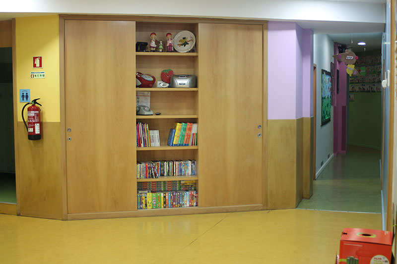 Bookshelf with children's books and toys in a preschool classroom