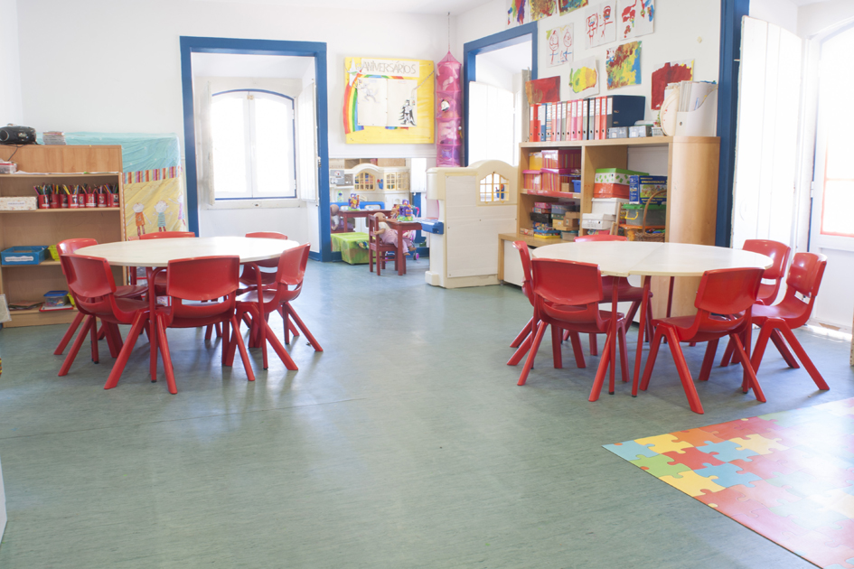 Preschool classroom with red chairs and tables