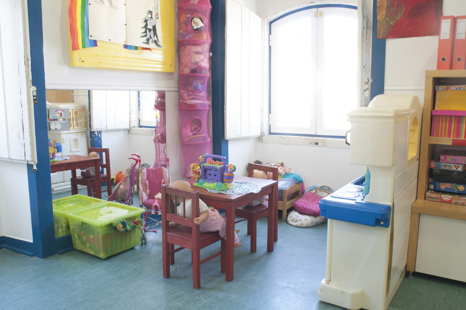 Preschool classroom with children playing and toys