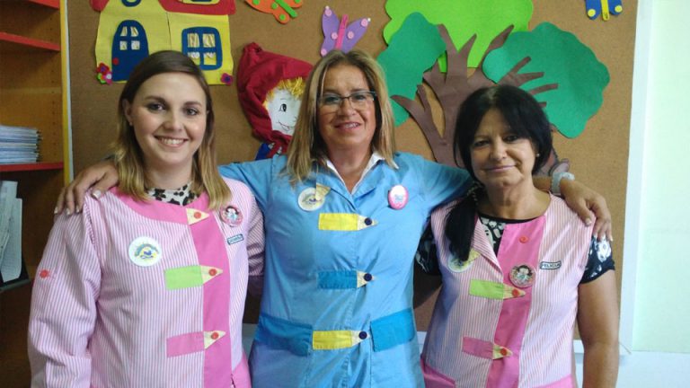 Three teachers at Os Cartolinhas preschool smiling for a photo