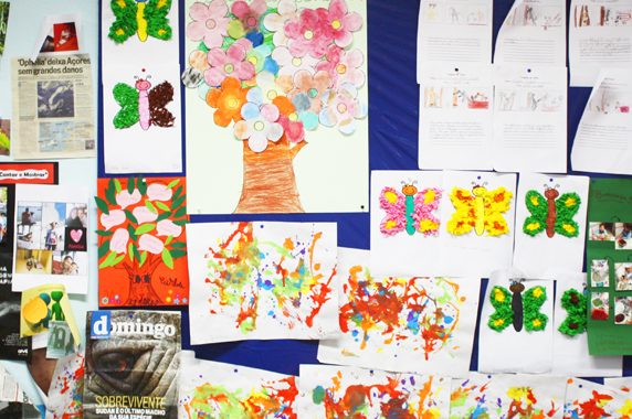 Preschool children's artwork on display, featuring colorful paintings and butterfly crafts.