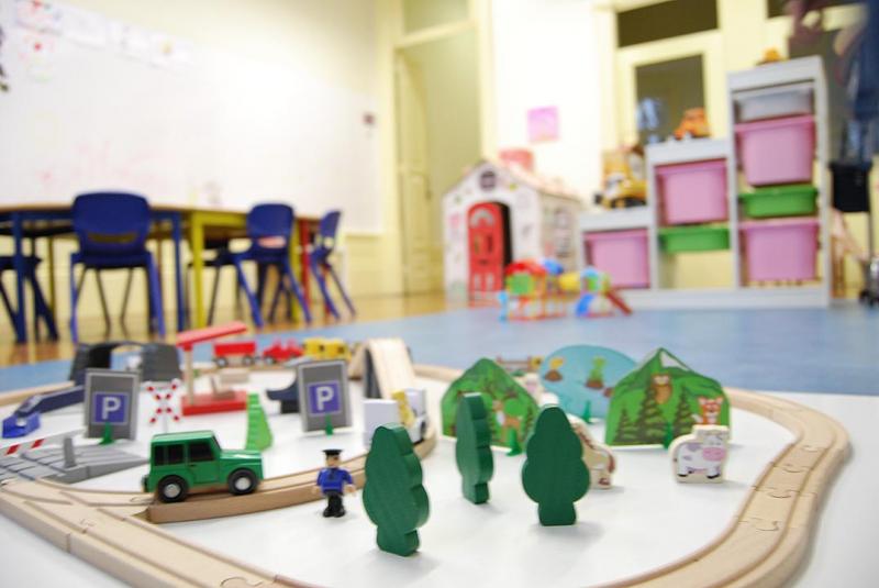 Preschool classroom with toy train set and play area