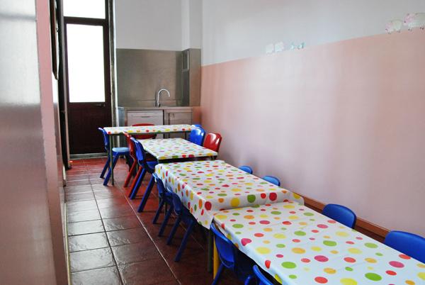 Preschool lunchroom with colorful tables and chairs