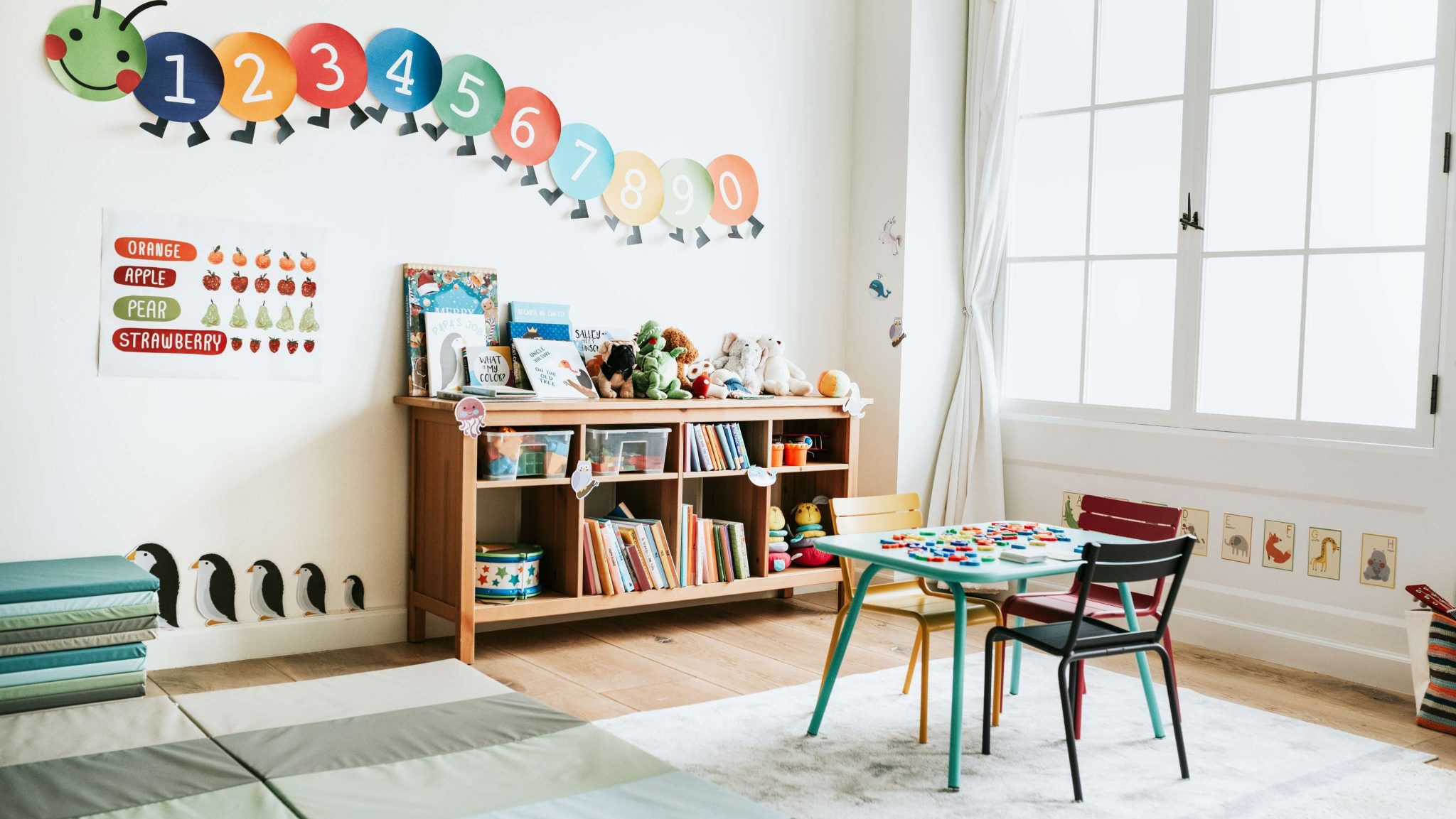 Preschool classroom with colorful decorations, books, and toys