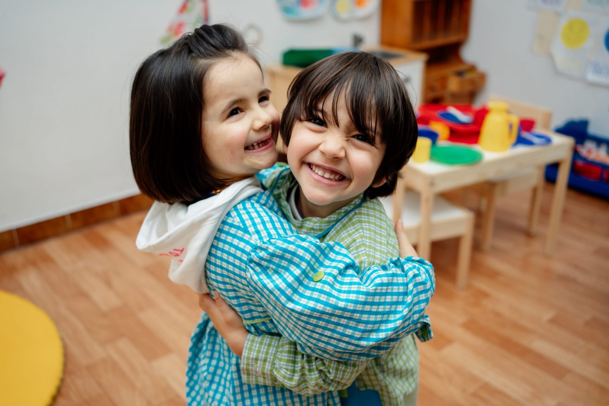 Preschool children hugging each other