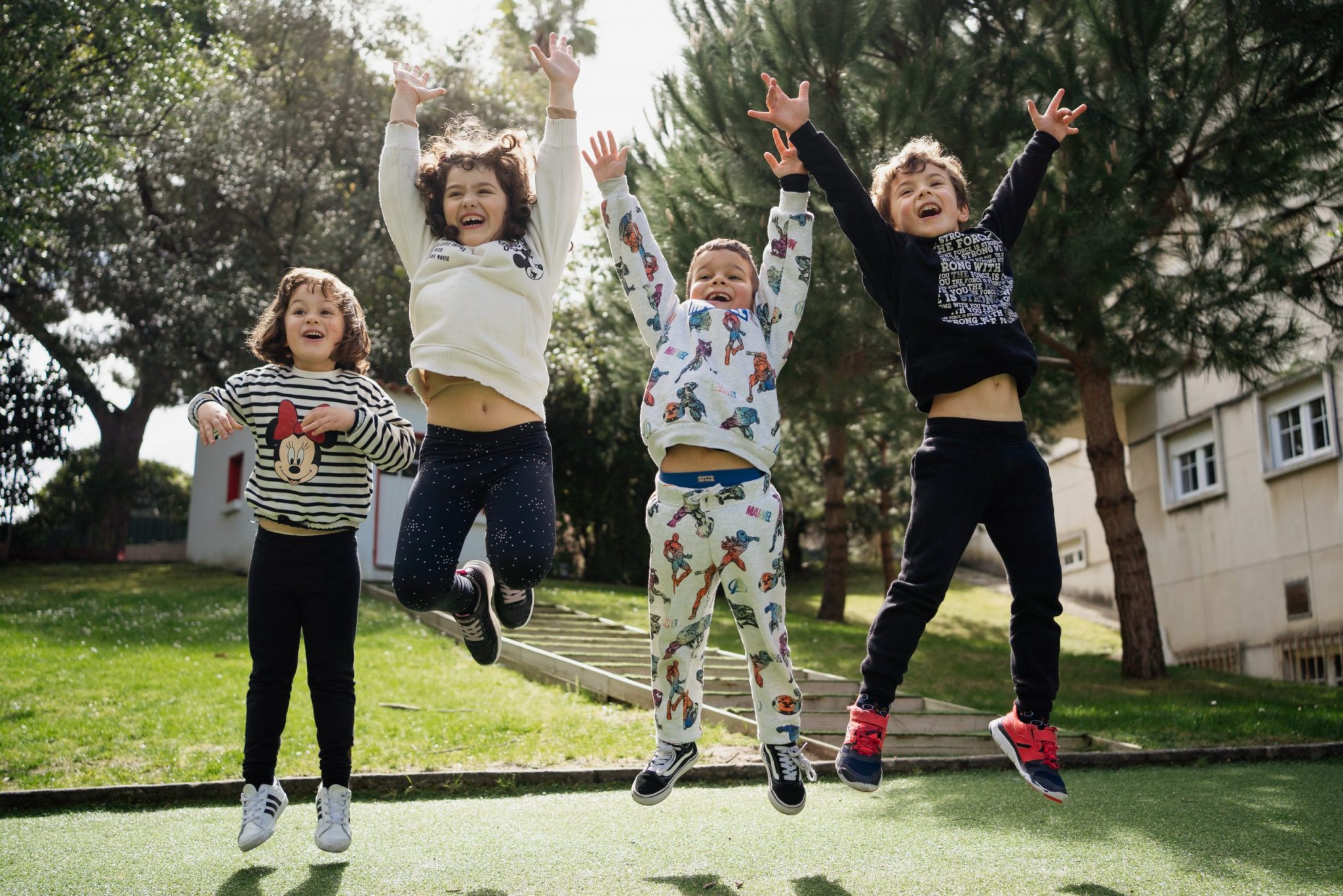 Preschool children joyfully jumping outdoors