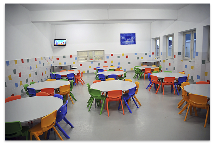 Preschool cafeteria with colorful tables and chairs