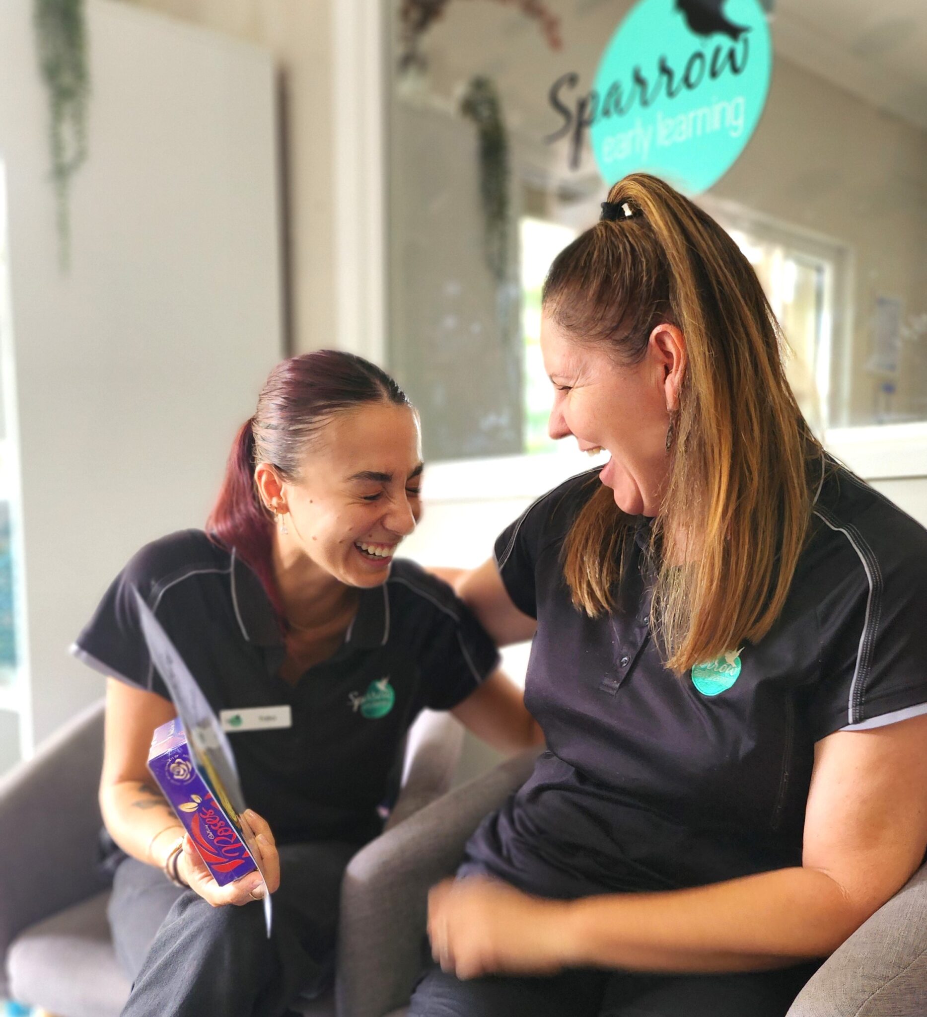 Two teachers at Sparrow Early Learning Seville Grove joyfully laughing together
