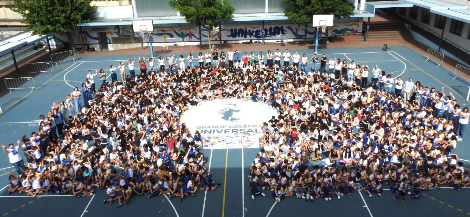 Students and teachers of Great Universal College forming the school logo on the playground