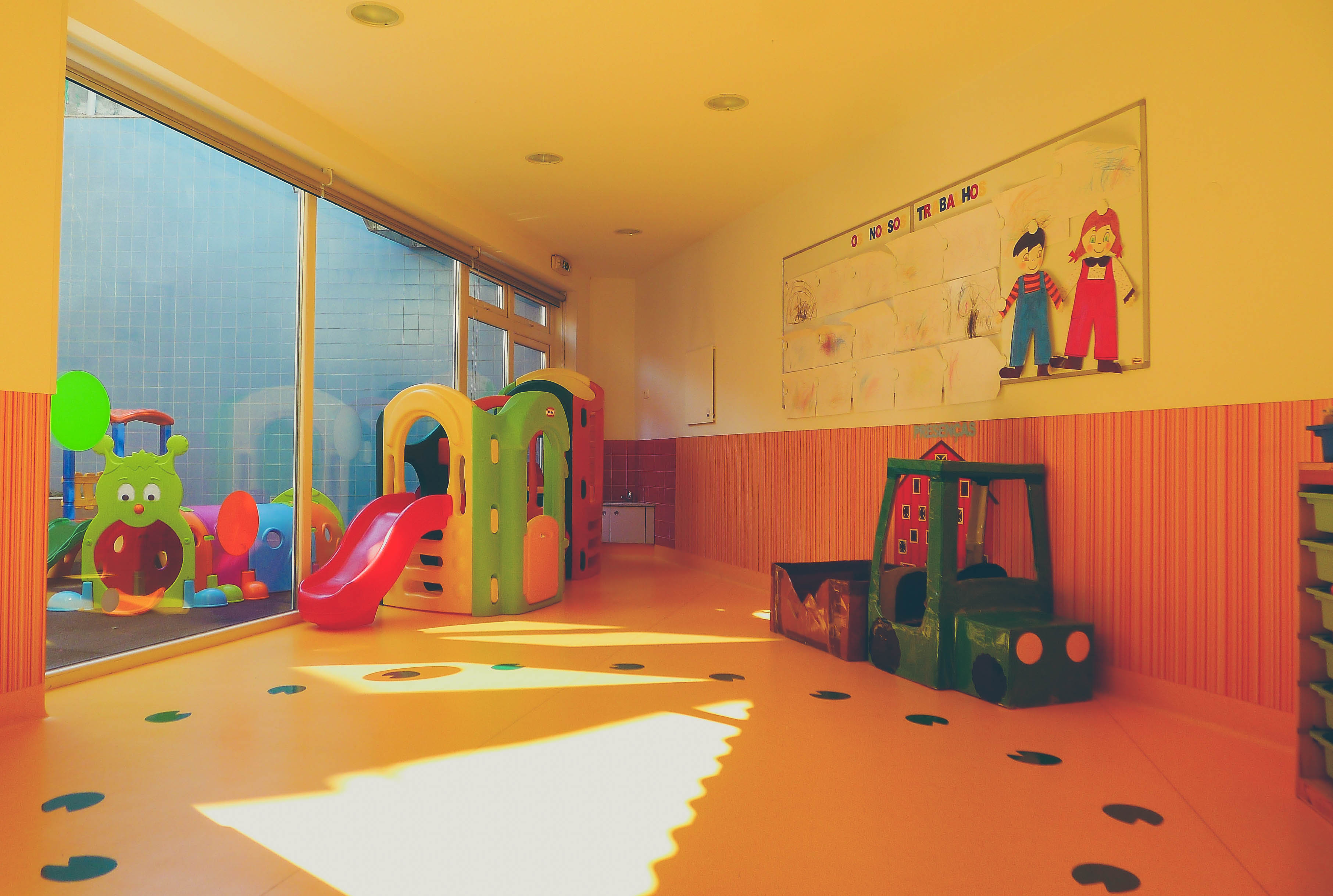 Preschool classroom with colorful toys and play structures